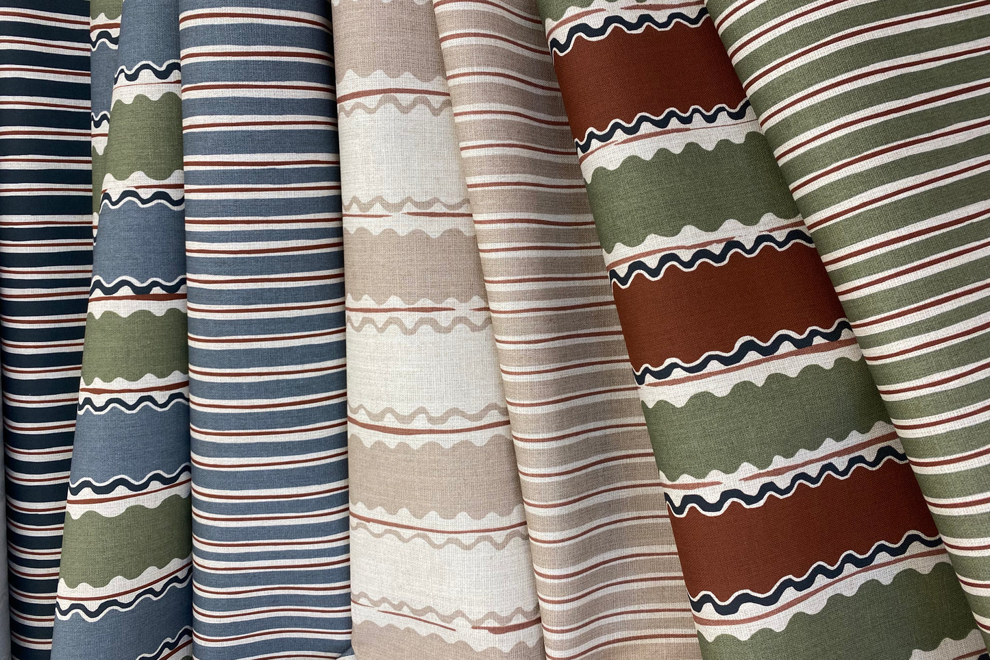 Collection of striped and patterned fabric swatches in various colors.