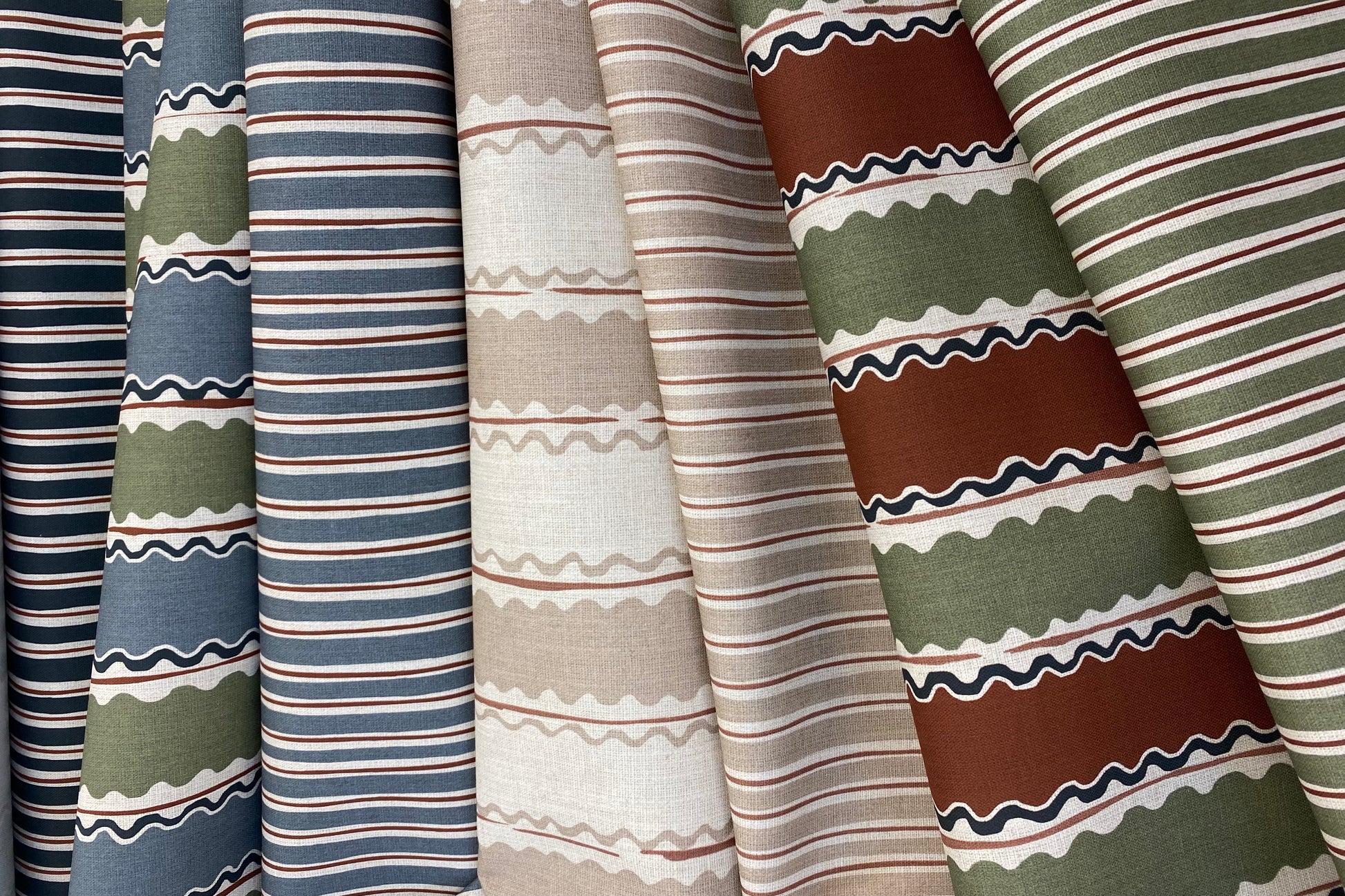 Collection of striped and patterned fabric swatches in various colors.